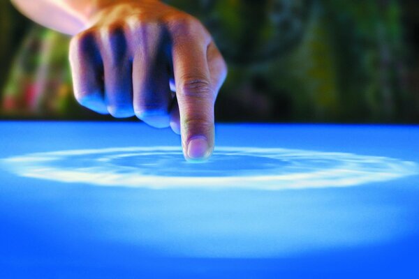 Index finger on the blue surface