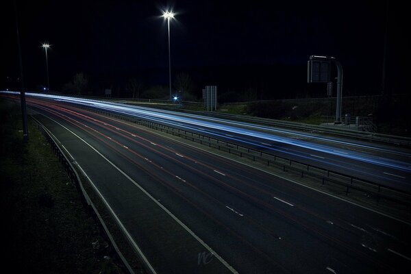 The night highway is illuminated by lanterns