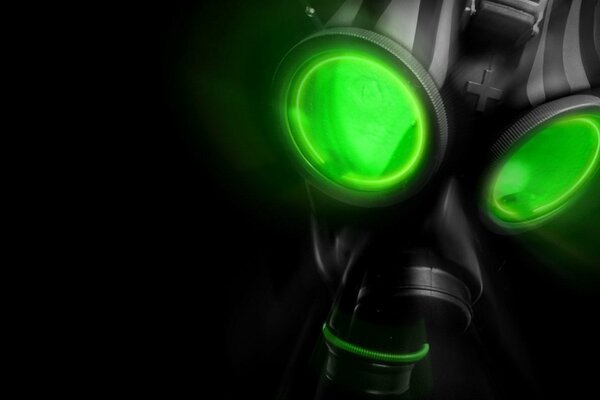 Gas mask with green eyes in the dark