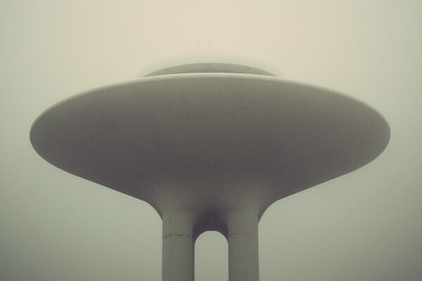 Flying saucer on a pedestal in the fog