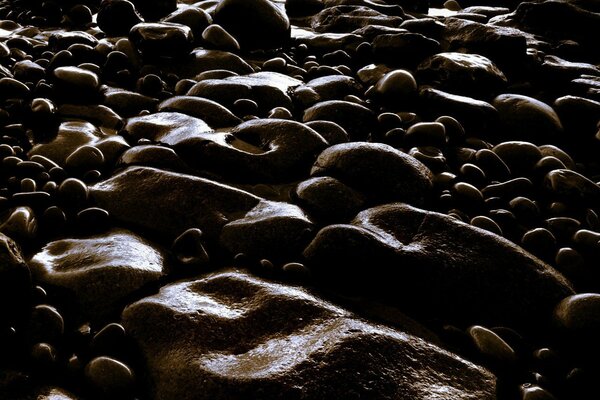 Night sunset on the shore of dark pebbles