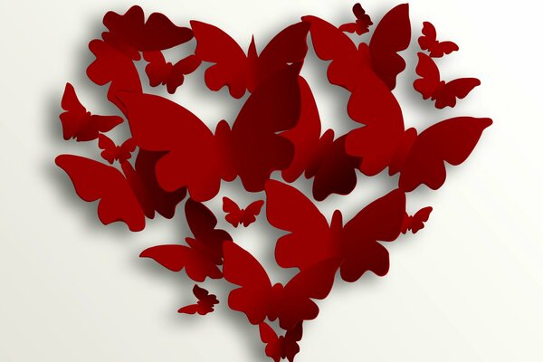 Cuore rosso di farfalle volanti