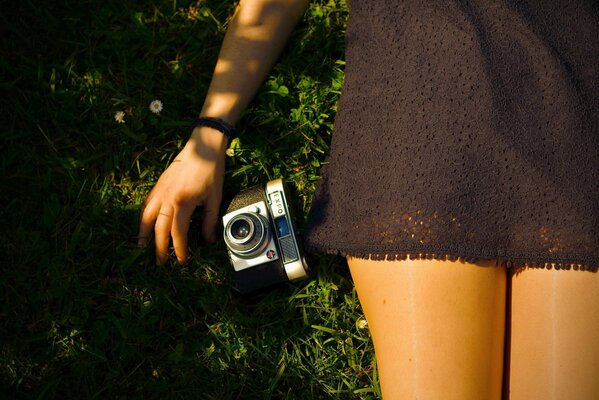 A girl in a short dress with a camera