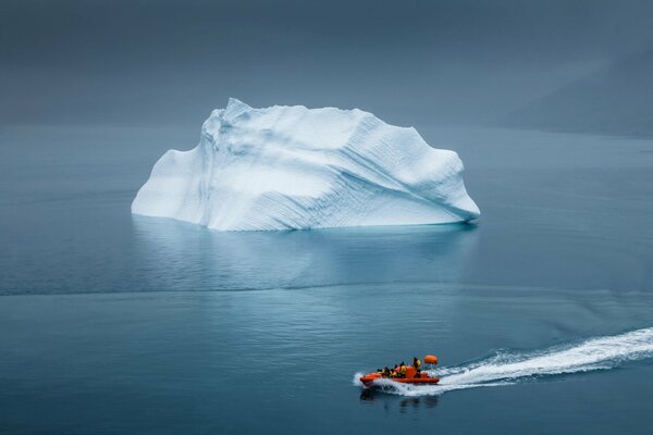 A lifeboat is approaching an icy iceberg