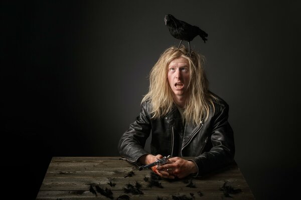 A man with a crow and feathers on his head