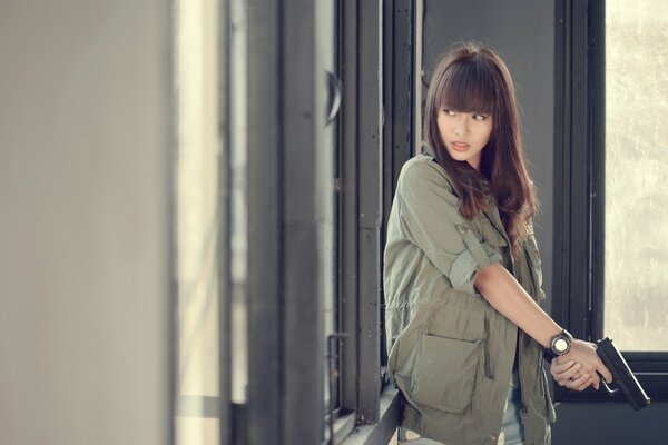 Asian girl with a gun in her hands