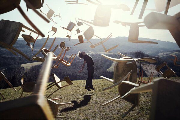 The man rose into the air along with the chairs