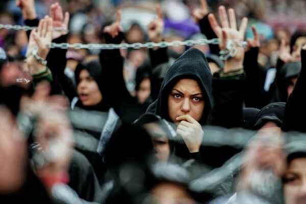 Black crowd with chains against