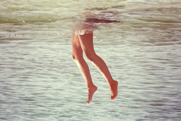 Legs sticking out of the water in the river