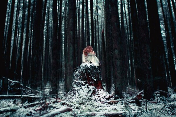 Ein Mädchen allein in einem verschneiten Wald in der Nacht