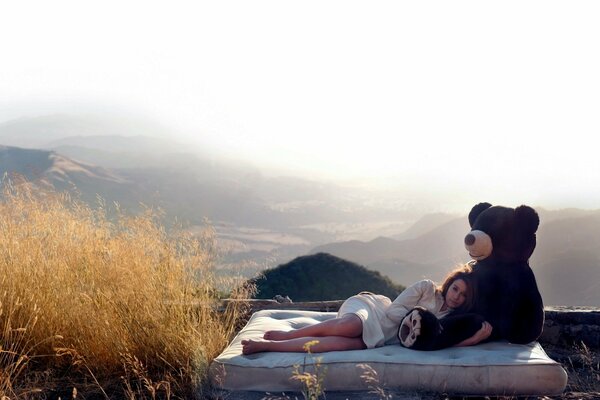 Girl and bear in the morning beauty