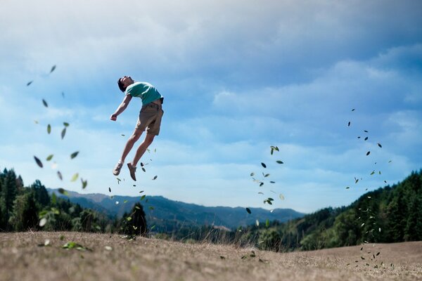 Photo of a man jumping in a field