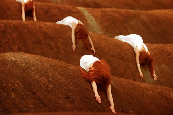 Red-haired women in white hugged the ground