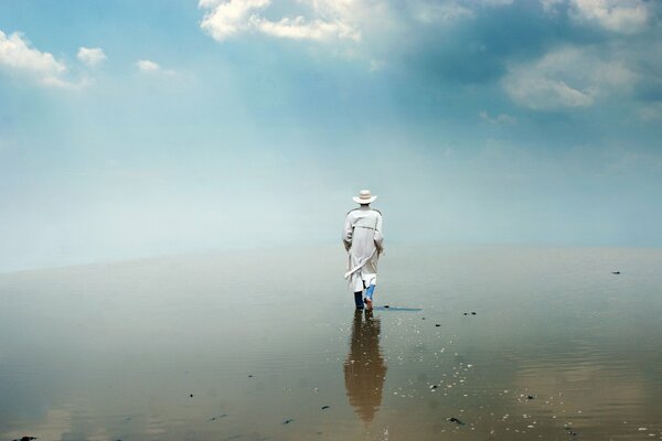 A man walks along the seashore