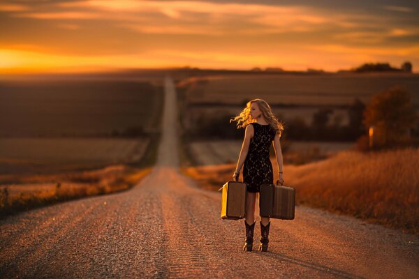 The girl set off on the road with suitcases