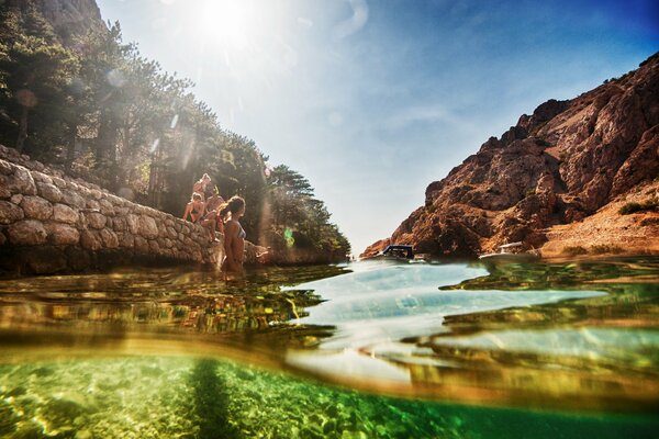 Photos of girls swimming in a lake in the mountains