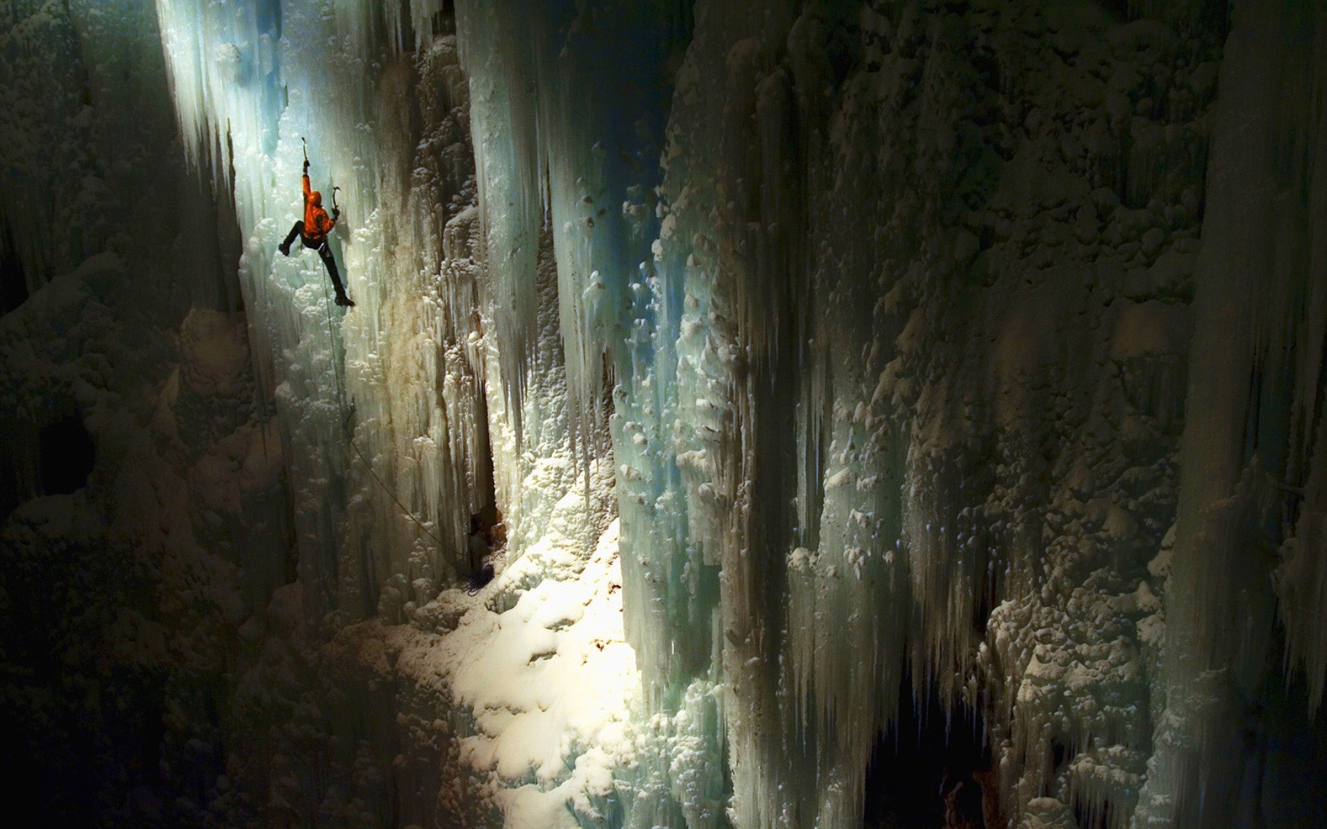 cave wall next height climber light rays surface target the situation