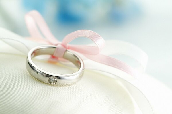 A beautiful wedding ring tied with a ribbon