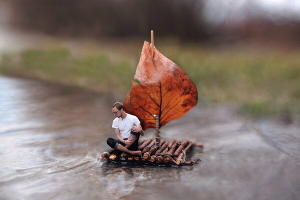 Photo of a guy on a wooden raft