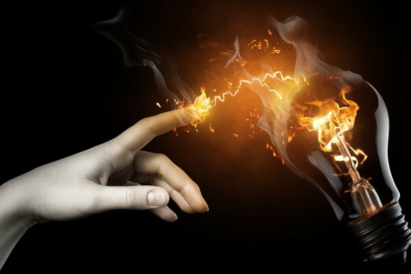 Hand with a light bulb on a black background