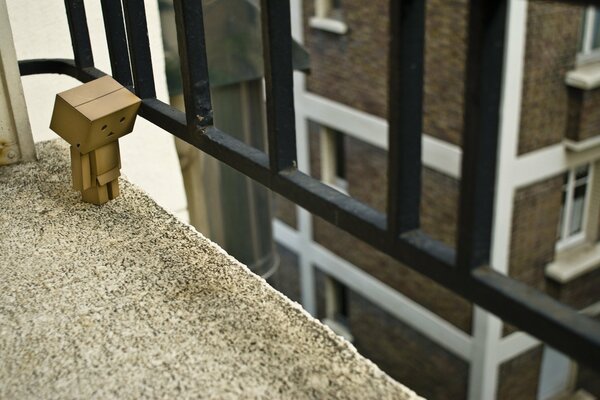 Danbo at the balcony fence of the house