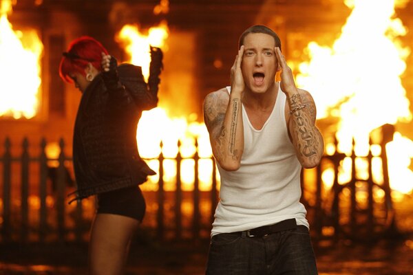 Singer Eminem on the background of fire with singer rihanna