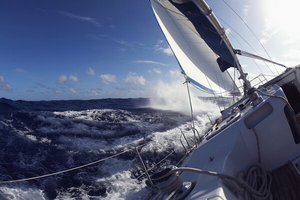 Yacht at sea on big waves