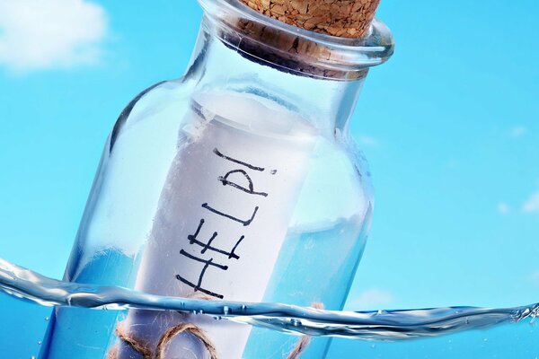 A message in a bottle with a cork. Text - help