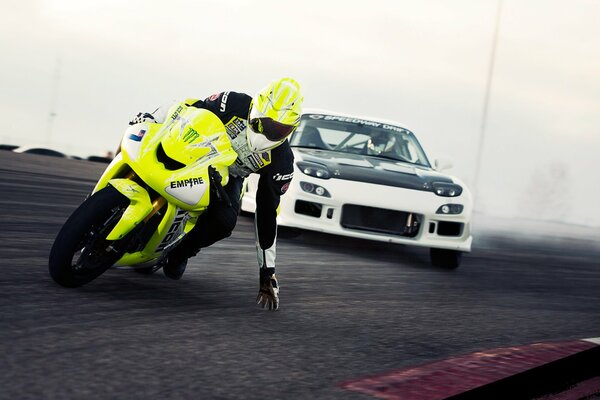 Motorcyclist and motorist driving on the road