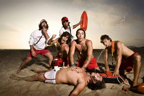 Lifeguards on the beach provide artificial respiration