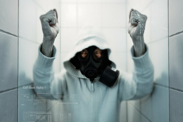 Angry man in a respirator mask behind glass