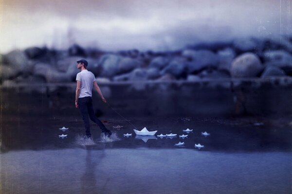 The guy poses next to the white boats