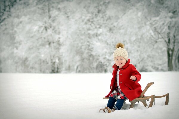 A bright girl against the background of a winter forest