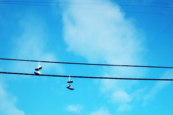 Boots hanging on wires