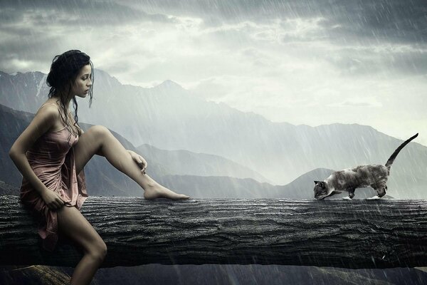 Niña y gato sentados bajo la lluvia en el tronco de un árbol