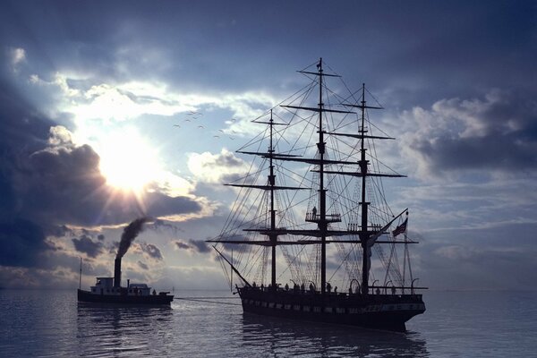 A tugboat drags a ship into the sea