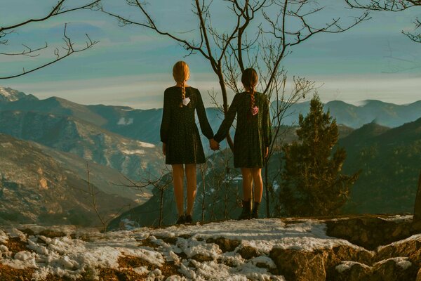 Two girls look at the mountains