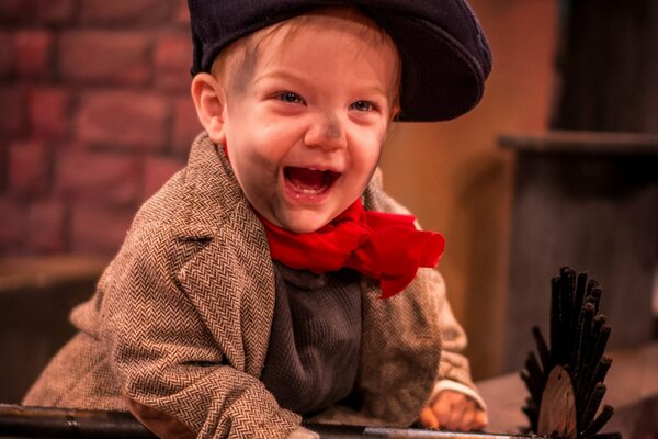 A dirty little boy in a cap