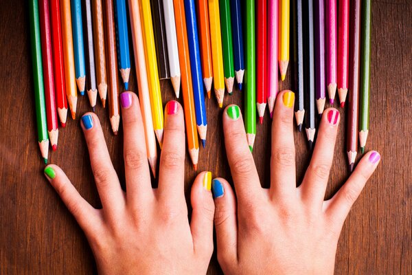 Bright manicure and colored pencils