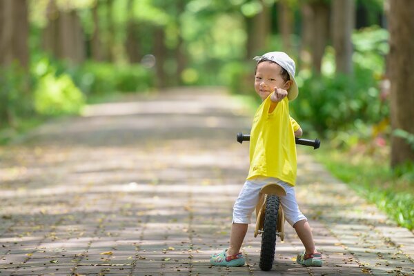 A boy on a bicycle with the mood of summer