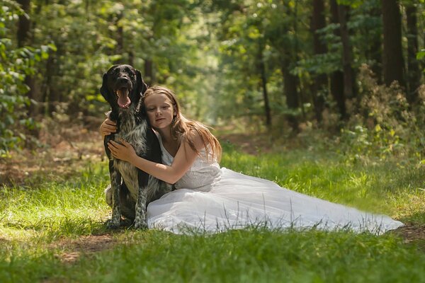 A girl and a dog in the silence of the forest