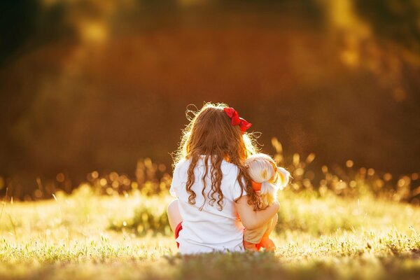 A girl with a bow in the rays of sunlight