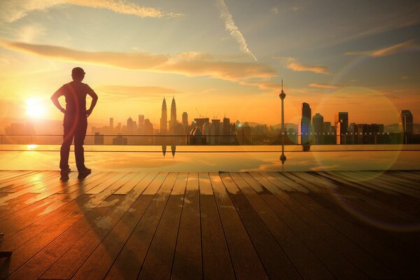 A boy on the embankment in the city