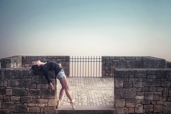 Girl on pointe shoes at the top of the tower