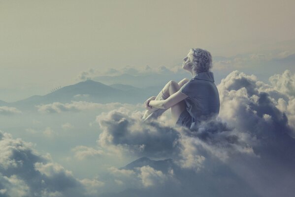 The blonde girl sits thoughtfully on the clouds