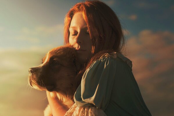 A girl with a dog in the sunlight