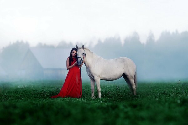 Chica en vestido rojo con caballo blanco