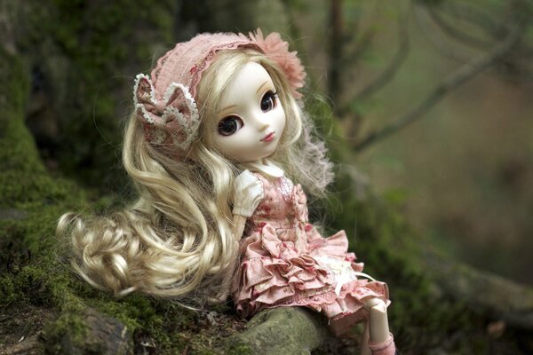 Cute doll in pink dress with ruffles