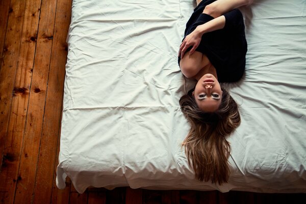 Girl with loose hair on the bed