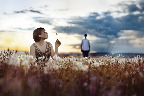A girl a guy and a field of dandelions